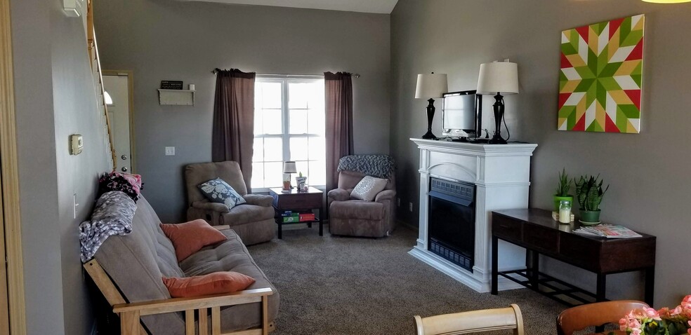 Living room with gas fireplace. - 6965 N 88th St