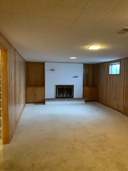 Basement family room with fireplace - 7991 E Hampden Cir