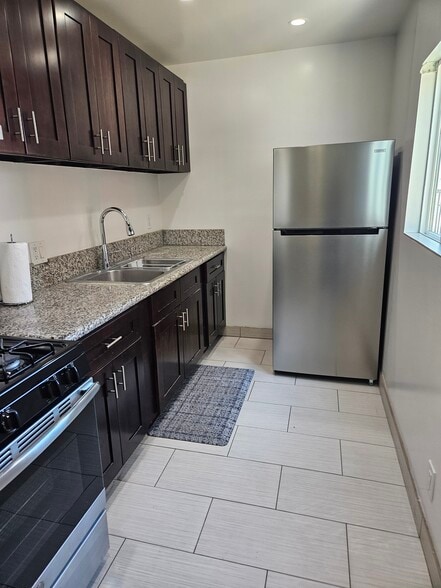 Full Kitchen with new 18 cubic refrigerator and lots of storage with window - 6043 Romaine St