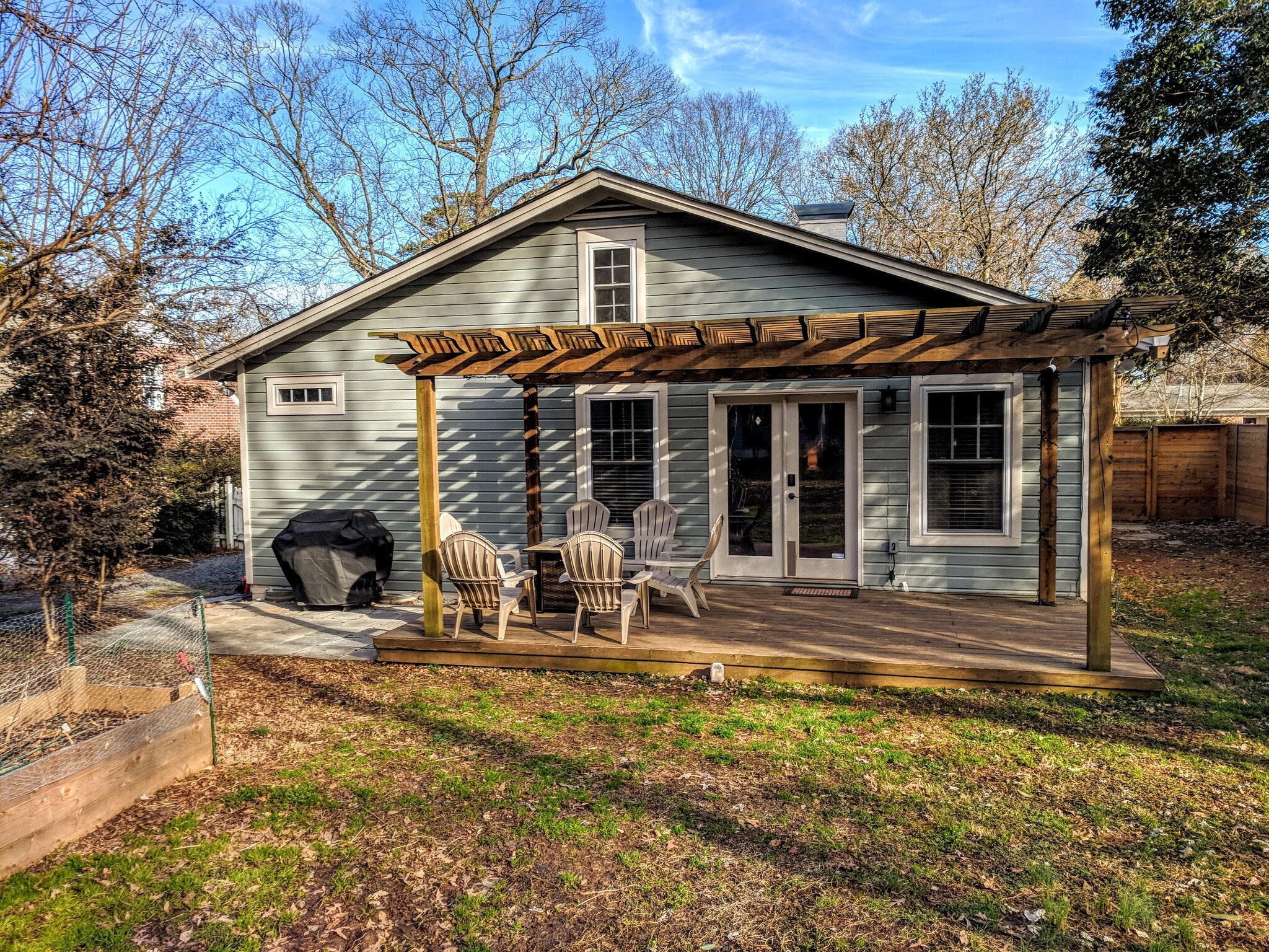 Back of house with large deck directly off main living area - 1627 Nassau Blvd