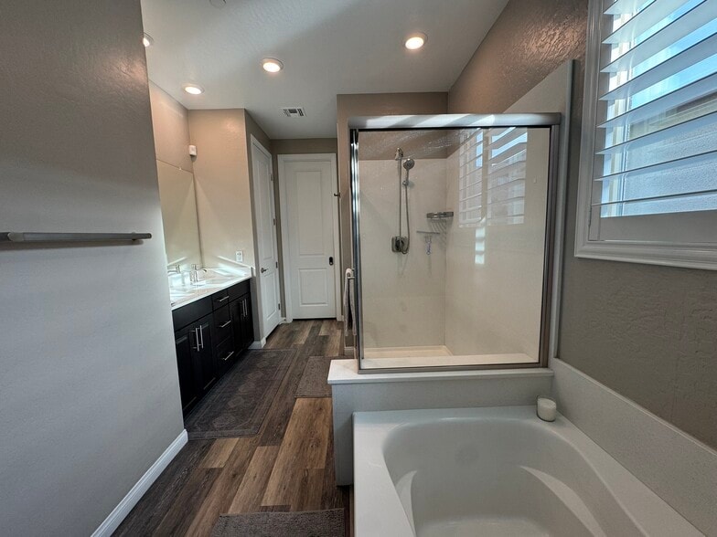 Primary ensuite bathroom with two sinks, tub, shower, linen closet, separate water closet. - 331 Coastal Redwood St