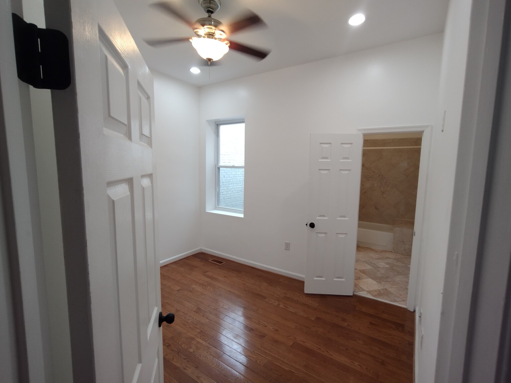 Second Bedroom Comfortable second bedroom featuring a large window for natural light, wood floors, r - 1933 4th St NW