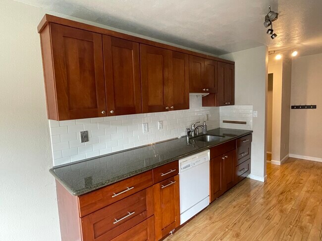 looking at north wall of cabinets in kitchen. (front entry is beyond). - 7001 Sand Point Way NE