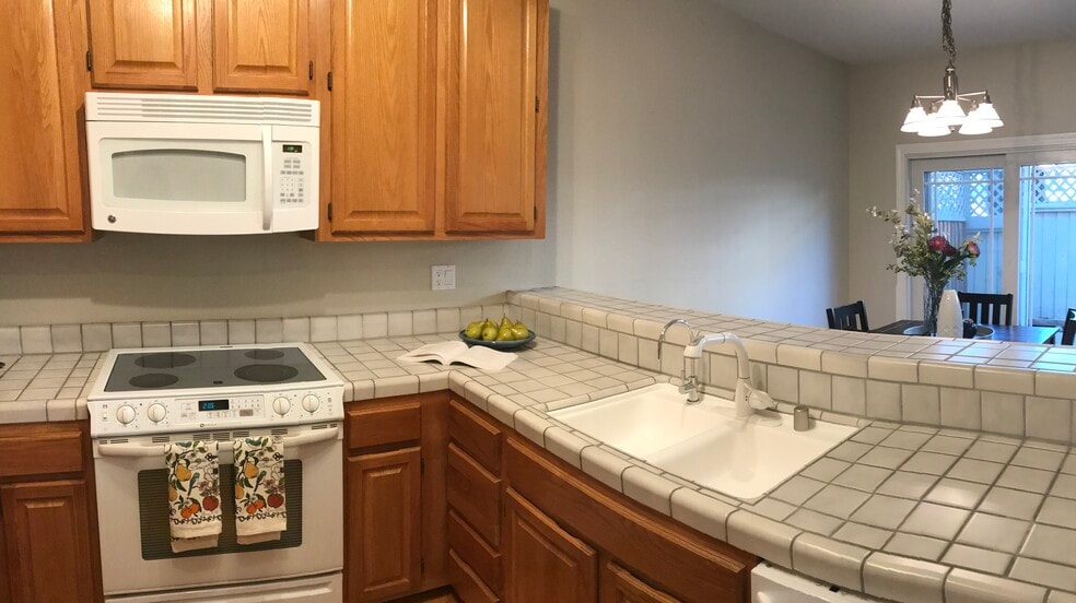 Kitchen with tiled counters and breakfast bar. - 203 Bean Creek Road
