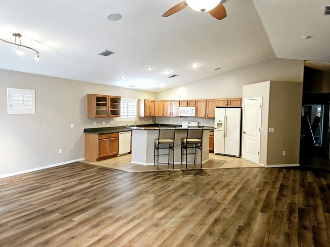 Open kitchen with large island - 11063 W Coppertail Dr