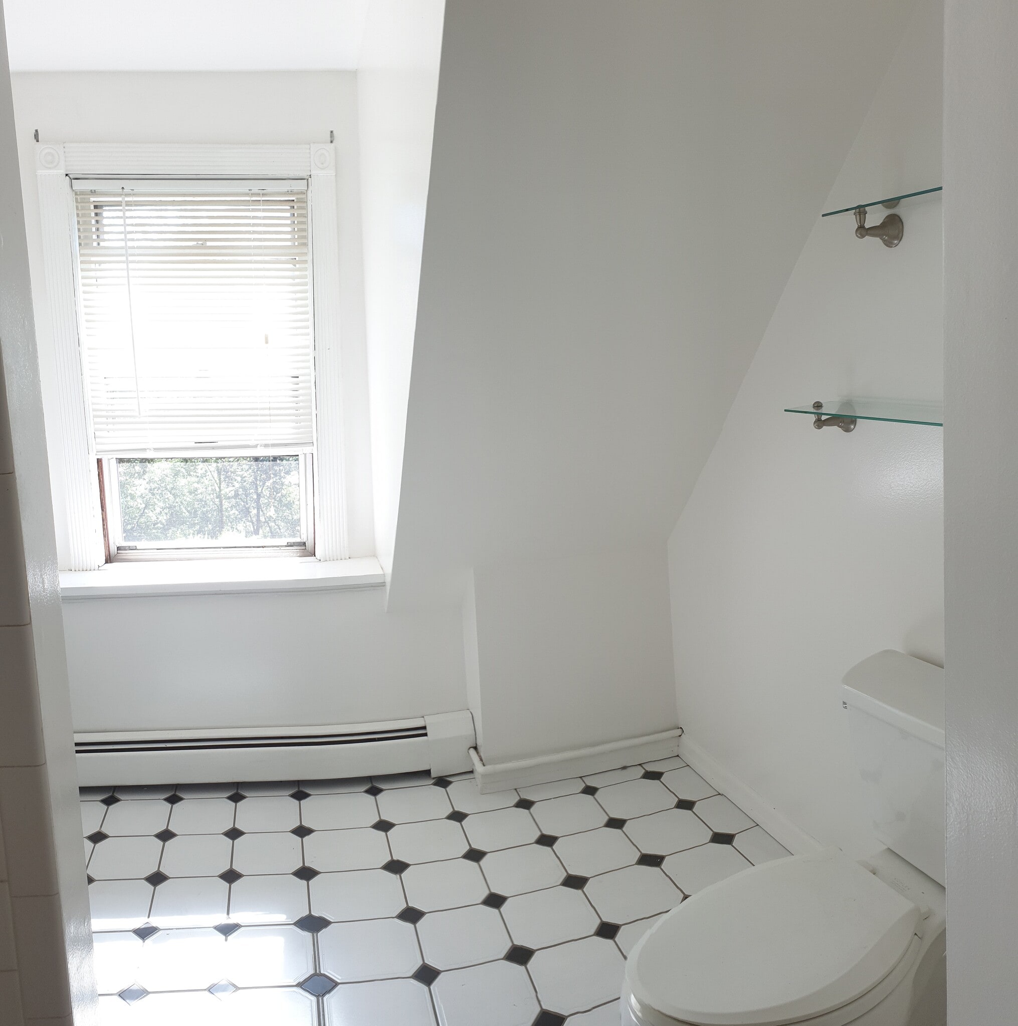 Filled with beautiful natural light, this bathroom features accent shelves, a brand-new vanit - 412 Morris Ave