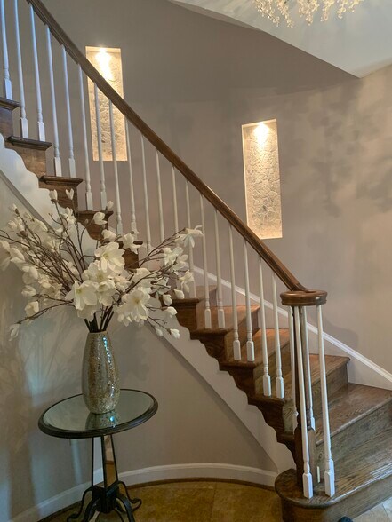 Entry with spiral stairs throughout and built in stone accents. - 2367 S Queen St