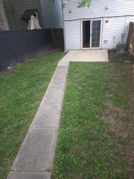 fenced in backyard with garage and patio - 366 E Mithoff St