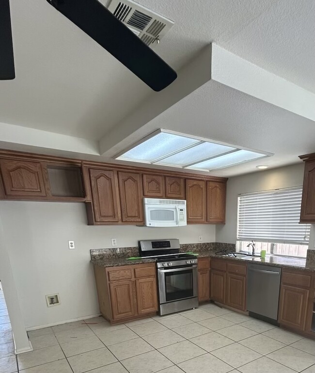 Kitchen with granite countertops and stainless dishwasher - 24388 Pantera Ct