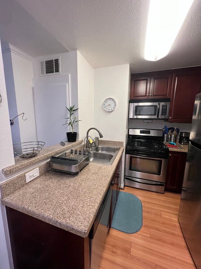 Kitchen with view into living room - 5520 Owensmouth Ave