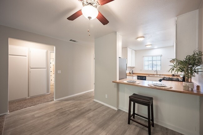 Kitchen and living room with ceiling fan - Oak Park Apartments