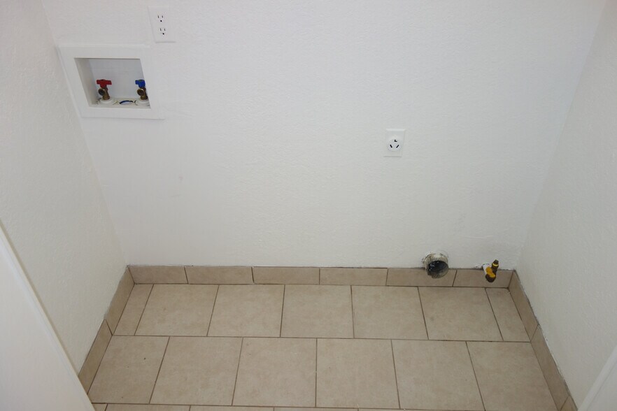 Laundry room is tucked behind bi-fold door in the hallway. Gas and Electric option for Dryer - 6604 S Utica Pl