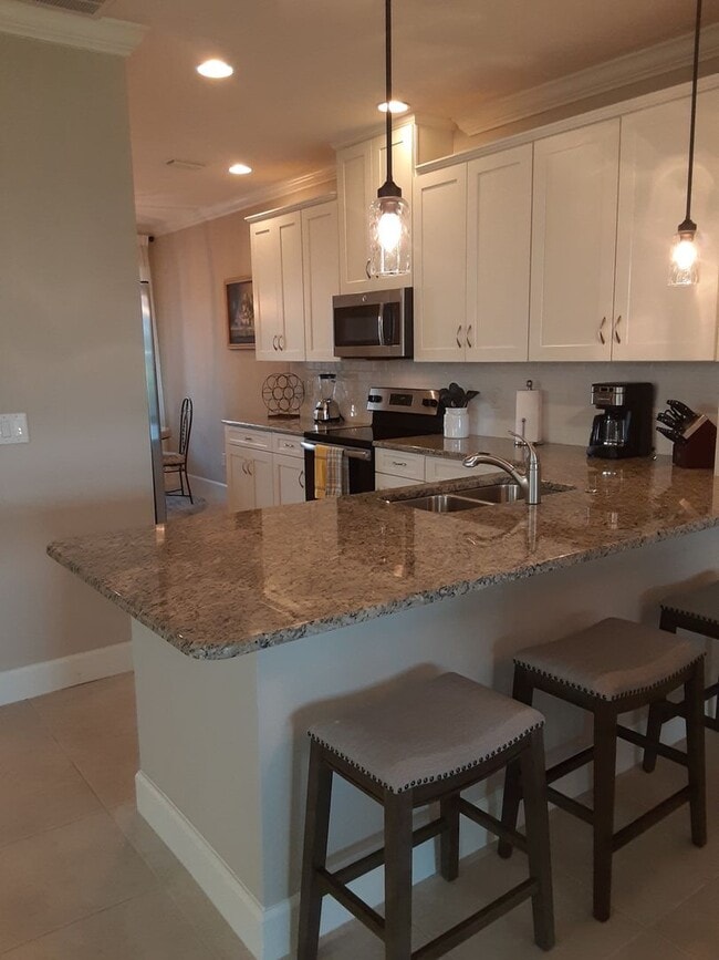 Building Photo - Seasonal/short term turnkey furnished Incredible 2/2 with den ground floor condo in resort Esplan...