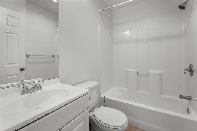 Building Photo - Light Filled Townhome Style Condo with Private Patios and Direct Access