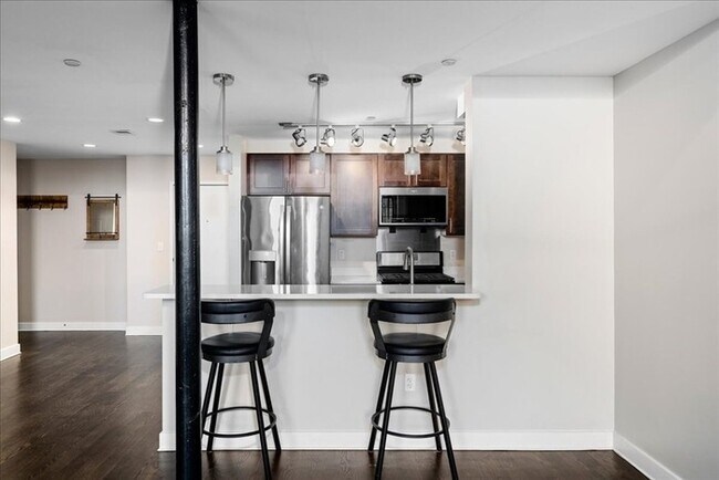Building Photo - Stylish Industrial Loft with Exposed Brick, High Ceilings & Modern Kitchen