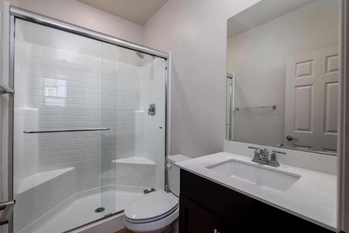 Ground-floor guest bathroom featuring a full bath with a glass-enclosed shower - 26549 Brightstone Dr