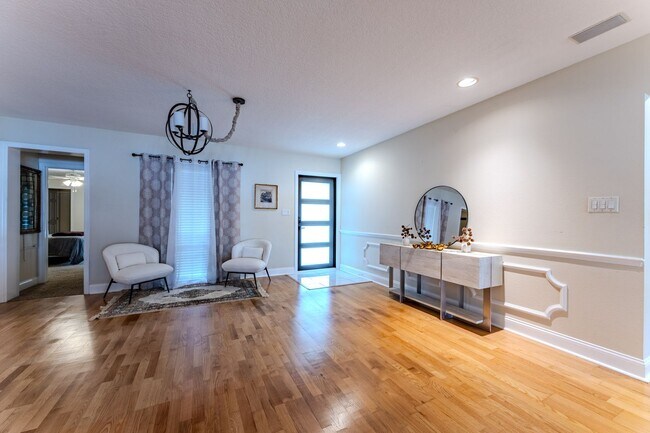 Building Photo - Lake Jessamine Luxury: Solar-Powered Waterfront Retreat on 1.14 Acres with Dock & Boathouse