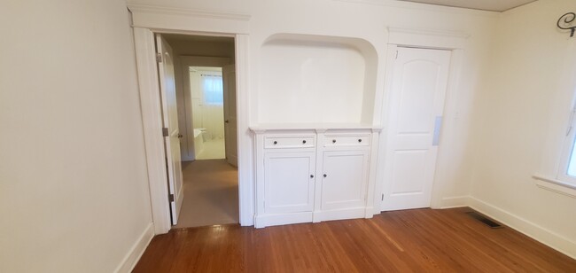 Hallway from bedroom to bathroom. Left door leads to the kitchen. - 1229 N Orange Grove Ave