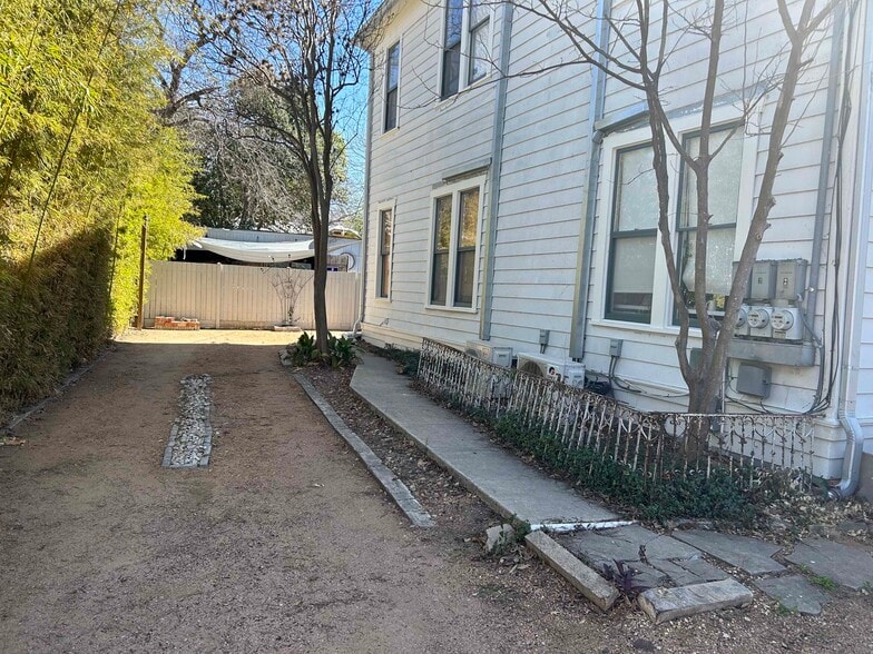 Walk toward backyard where Apt 1 has it's own private entrance with designated parking - 704 E Guenther St