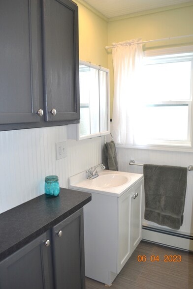 upstairs full bath has linen cabinets with a "grooming counter" - 222 W Peck St