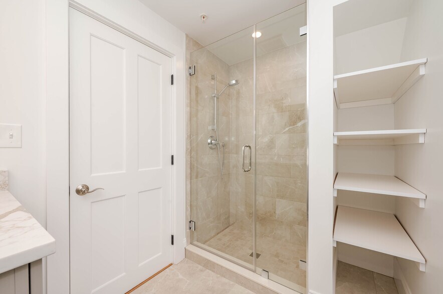Custom tiled shower with shelving for linens - 361 Miller Ave