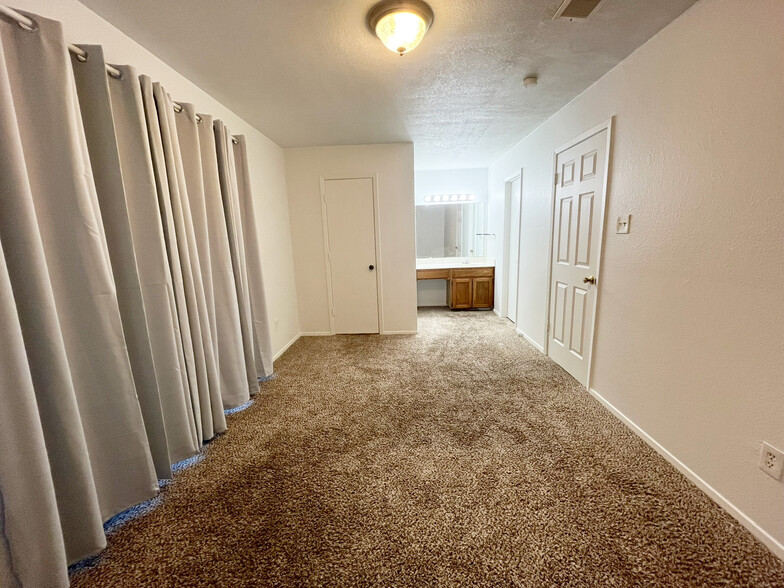 The spacious primary bedroom has ample room for a king-sized bed with space left over for furniture - 4917 Jamesway Rd