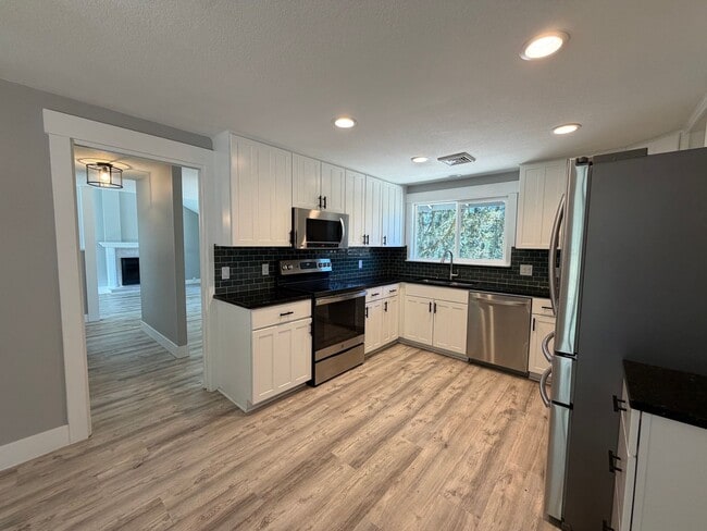 Building Photo - Spacious 4BR/3BA Home with Deck, Fenced Yard & Garage