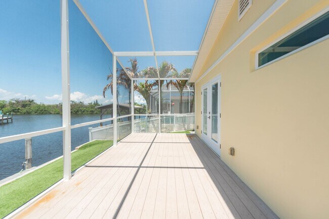 Building Photo - Live the ultimate Space Coast waterfront lifestyle at this stunning beachside canal home in Satel...