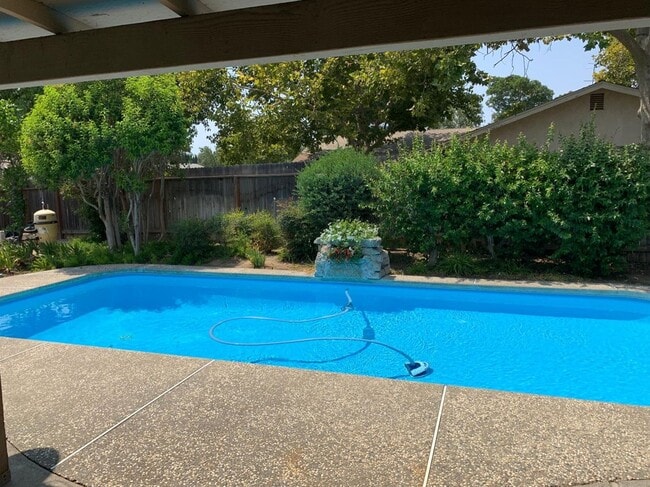 Building Photo - Enjoy the Backyard Pool at This 4-Bedroom ...