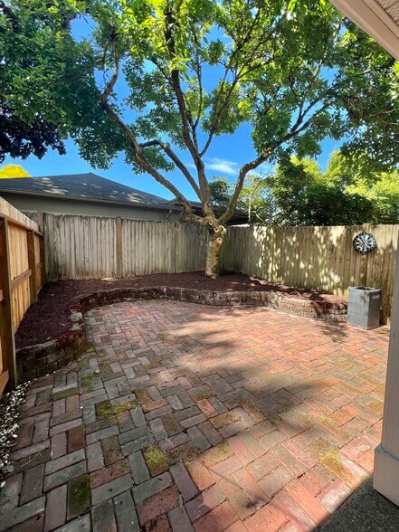 Private fenced patio shaded by mature tree - 12713 Greenwood Ave N