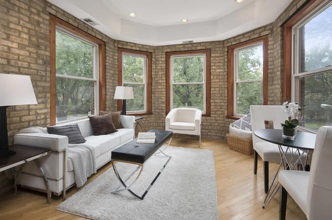 sunny living room with exposed brick and central air - 1332 W Greenleaf Ave