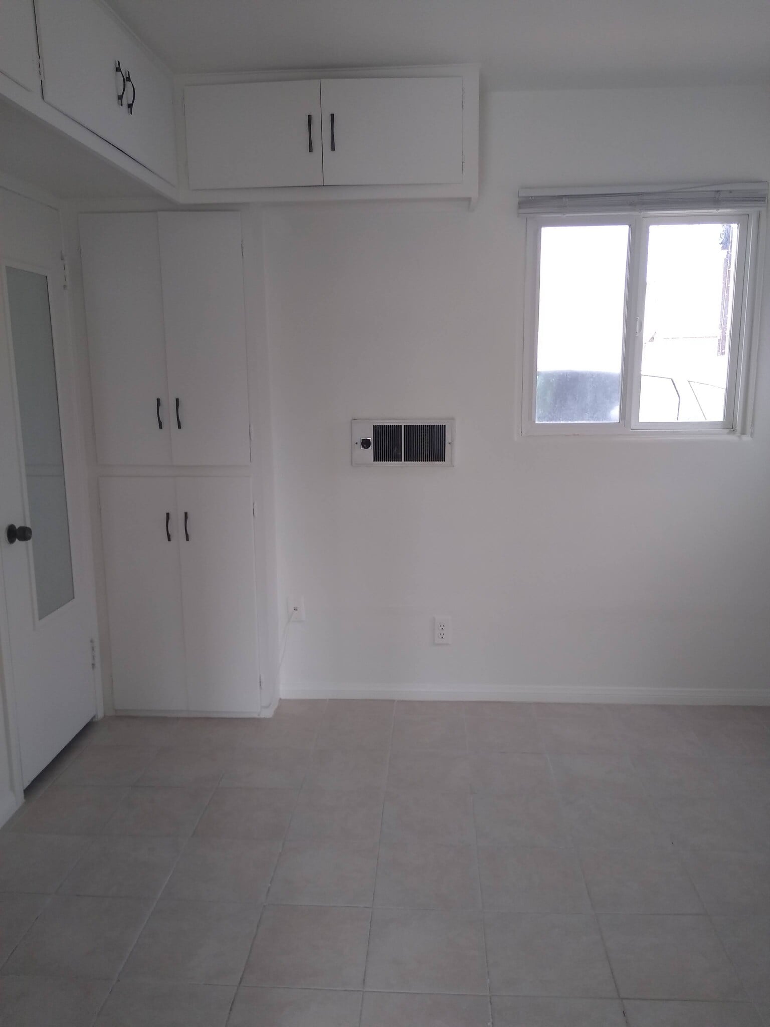 Bedroom. Cabinets and built-in wall heater. - 4127 Everts St