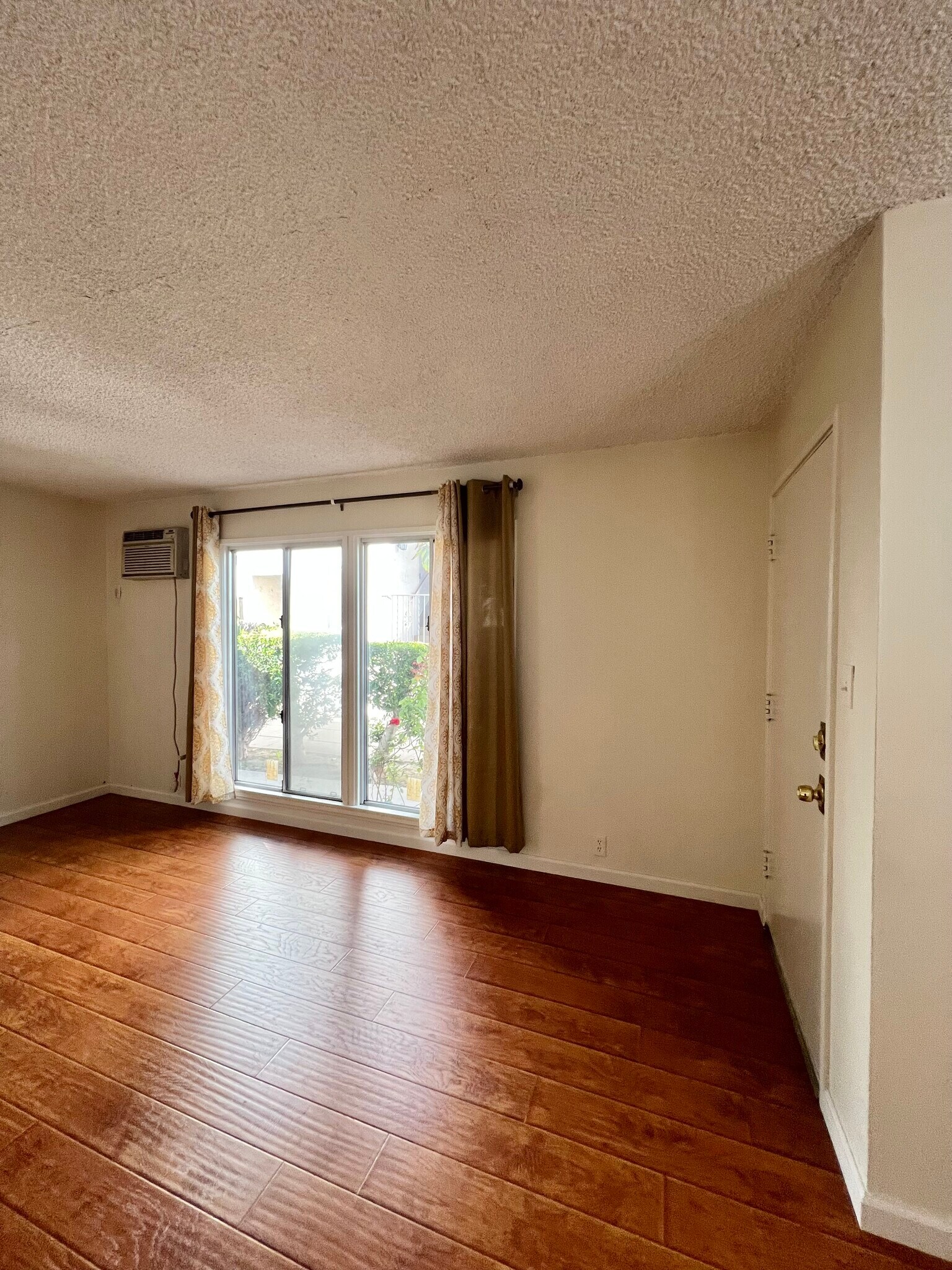 second angle of living room/front room. Air conditioner included. - 715 N Jackson St