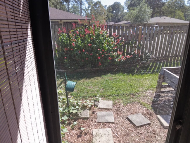 view of lovely backyard with vines and raised garden - 4415 NW 41st Plz