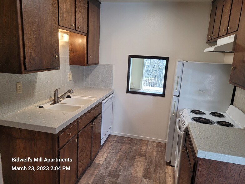 Kitchen with pass-through window to Living Room - Bidwell's Mill Apartments
