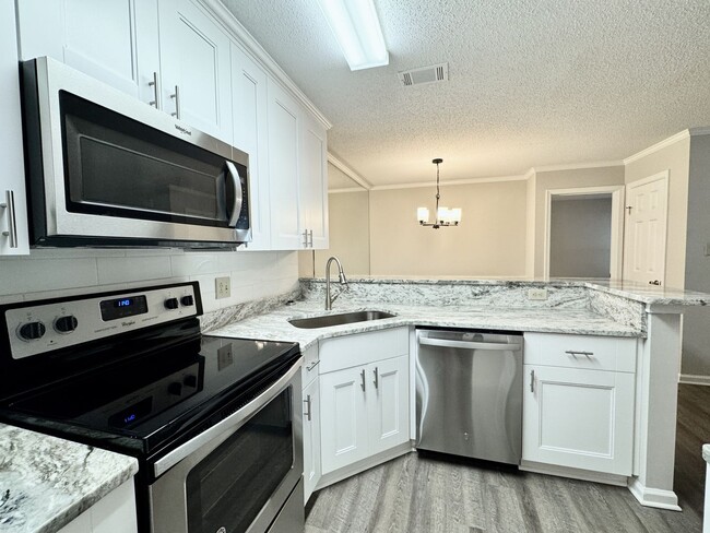 Building Photo - Updated 1st Floor/1-Level Condo Available NOW & Rent Includes Water, Sewer, Trash, Landscaping, F...