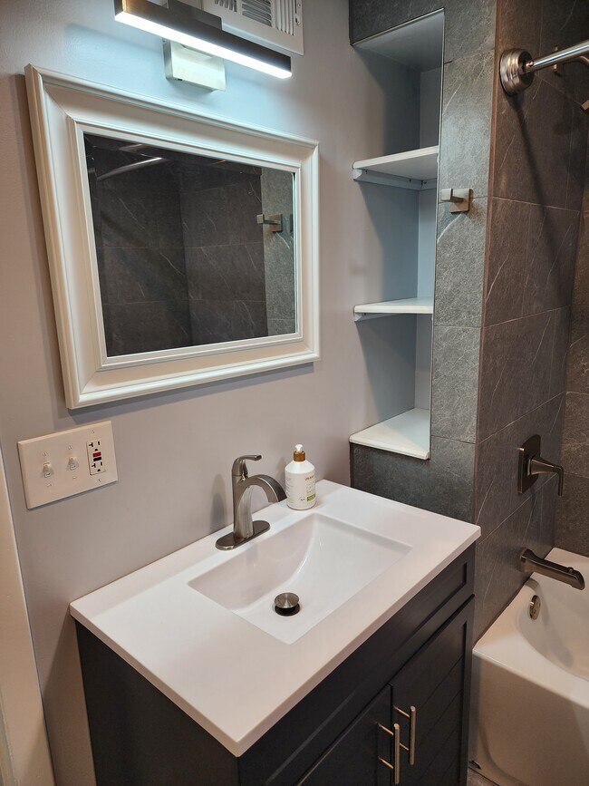 Newly renovated bathroom with lots of storage and LED lighting - 100 Manning Pl