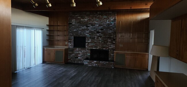 Building Photo - This is a spacious house featuring four bedrooms and two bathrooms, along with a two-car garage.