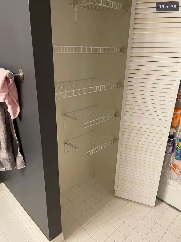 linen closet in bathroom - 23 Pierside Dr