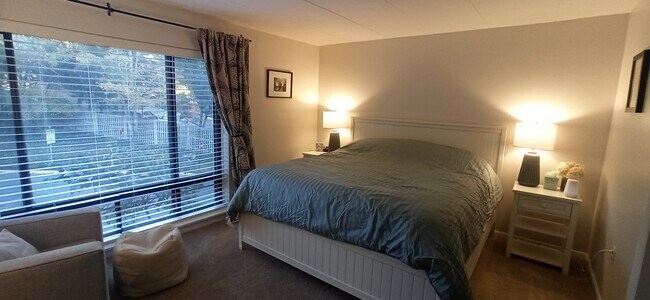 Huge master bedroom with floor to ceiling windows and garden views for added privacy - 100 Roberts Ln