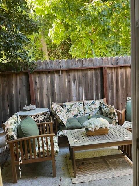 private patio shaded by mature trees - 4337 Rhodes Ave