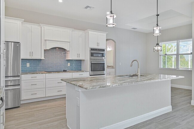 Building Photo - NOW AVAILABLE - Gorgeous Pool Home ~ NW Cape ~ 3 Car Garage ~ On Canal!