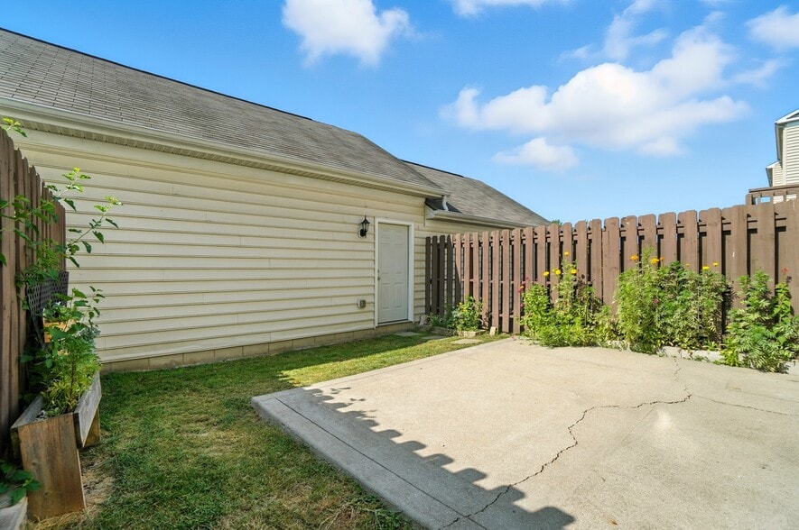 Private patio and yard with access to garage - 6169 Needletail Rd