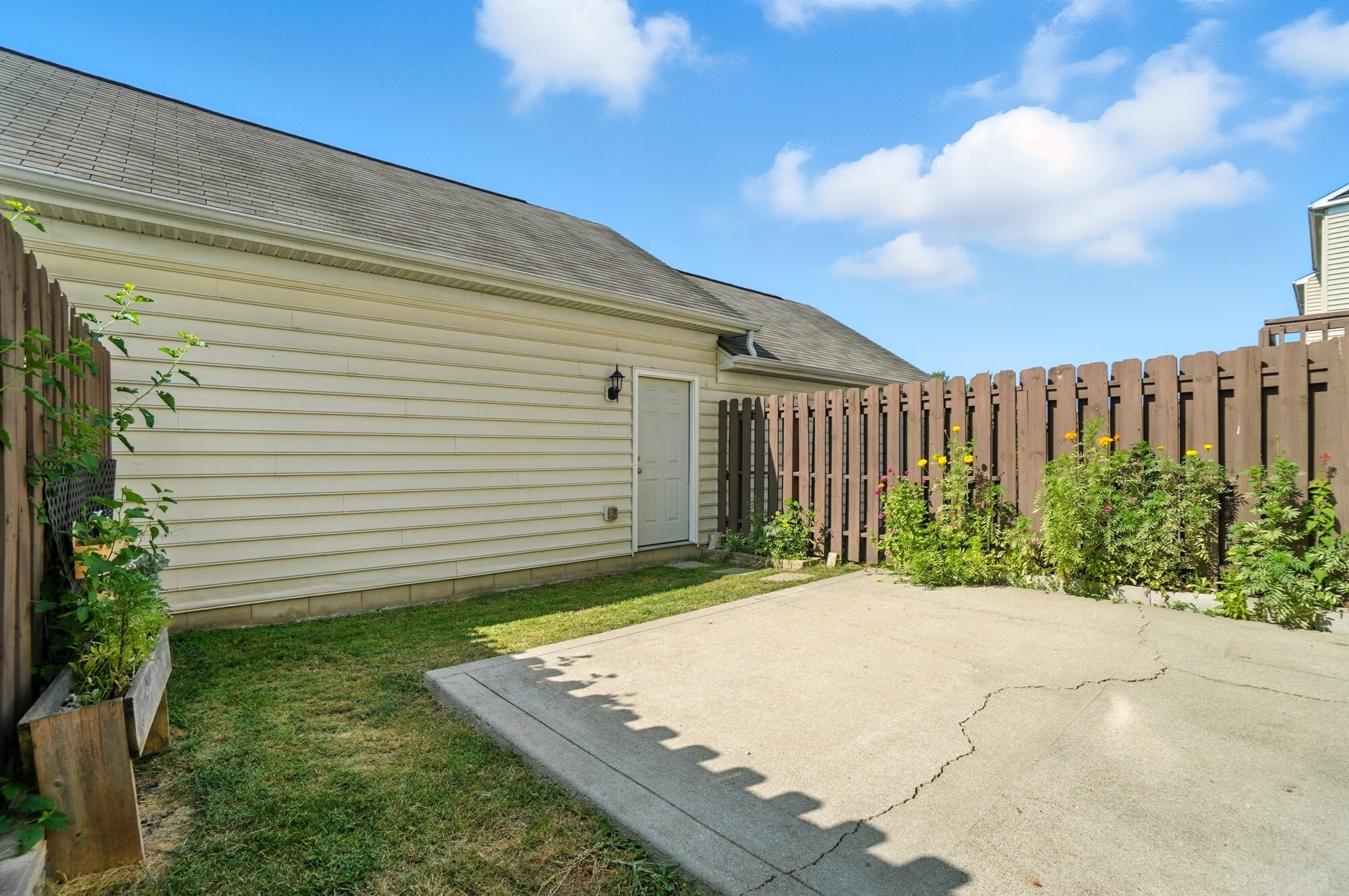 Private patio and yard with access to garage - 6169 Needletail Rd