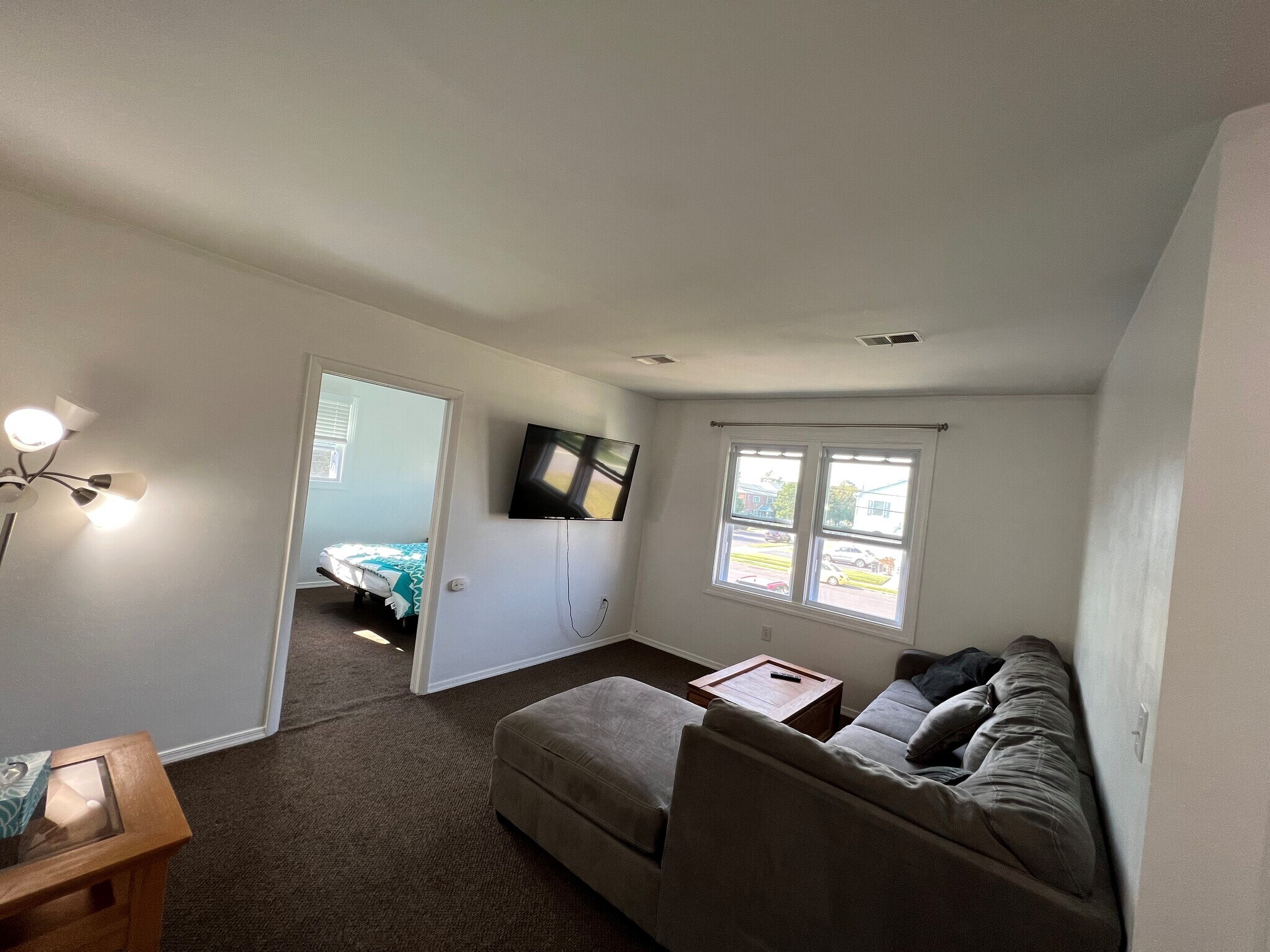 Living room with flat screen TV. WiFi included with the rent. - 100 Manning Pl
