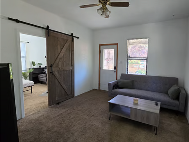 Living Room with Ceiling Fan, A/C, Rustic Barn Door to 2nd Bedroom / Office, Sofa Bed - 1512 17th Ave S