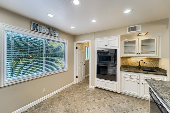 Kitchen showing wet bar and door to side pantry - 6256 Shoup Ave