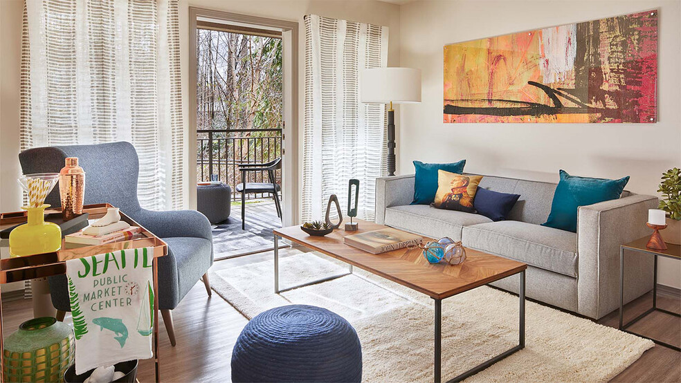 Apartment Living Room with wood flooring and balcony. - Griffis North Creek