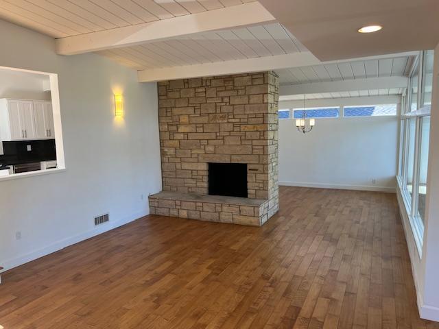 Living room with wood-burning, gas-assisted fireplace and dining room behind the fireplace - 2812 Anchor Ave