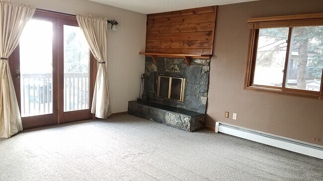 Fireplace with door to deck - 3031 E 42nd Ave